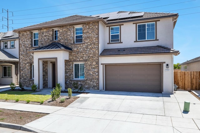 2054 N Laverne Ave, Fresno, CA 93727 - view of front of property with stone siding, driveway, stucco siding, solar panels, and a garage