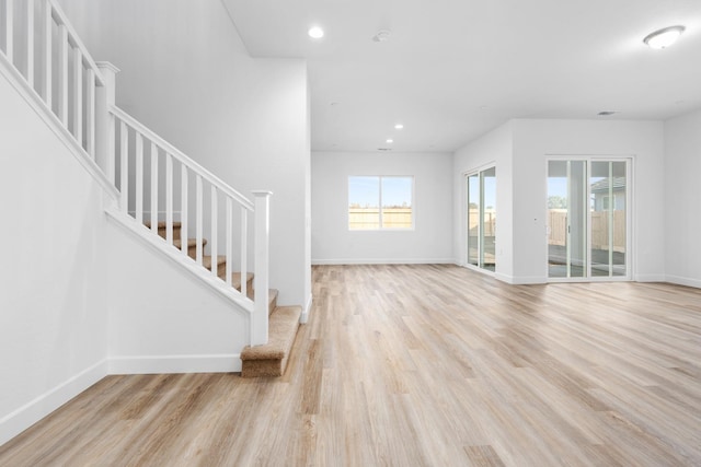 2054 N Laverne Ave, Fresno, CA 93727 - unfurnished living room with light wood finished floors, stairway, baseboards, and recessed lighting