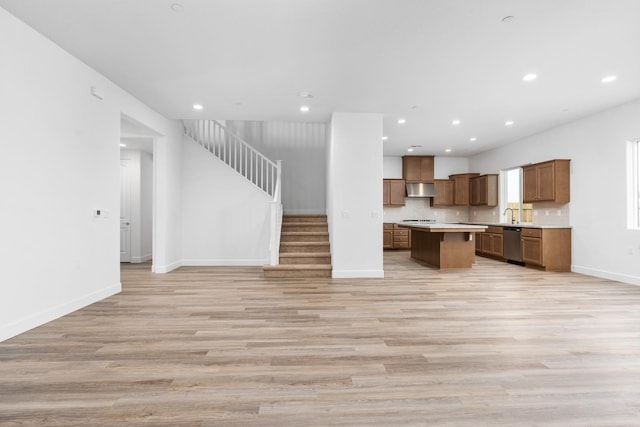 2054 N Laverne Ave, Fresno, CA 93727 - kitchen with stainless steel dishwasher, open floor plan, recessed lighting, a kitchen island, and light wood-style flooring