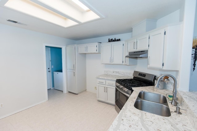 6412 E Inyo St, Fresno, CA 93727 - kitchen with under cabinet range hood, stainless steel gas range, a sink, white cabinets, and light floors