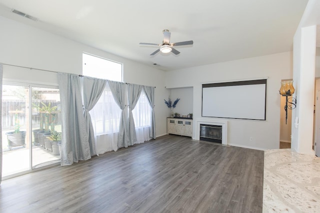 6412 E Inyo St, Fresno, CA 93727 - home theater featuring ceiling fan, a glass covered fireplace, wood finished floors, and baseboards
