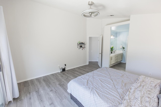 6412 E Inyo St, Fresno, CA 93727 - bedroom featuring light wood finished floors, baseboards, and connected bathroom