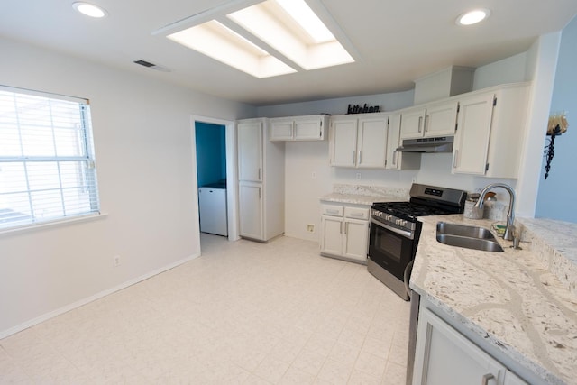 6412 E Inyo St, Fresno, CA 93727 - kitchen featuring gas range, a sink, under cabinet range hood, light stone counters, and white cabinets