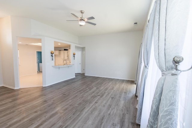 6412 E Inyo St, Fresno, CA 93727 - unfurnished living room with ceiling fan, wood finished floors, a sink, and baseboards