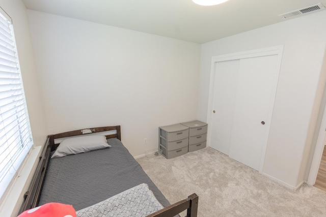 6412 E Inyo St, Fresno, CA 93727 - carpeted bedroom featuring multiple windows, a closet, and baseboards