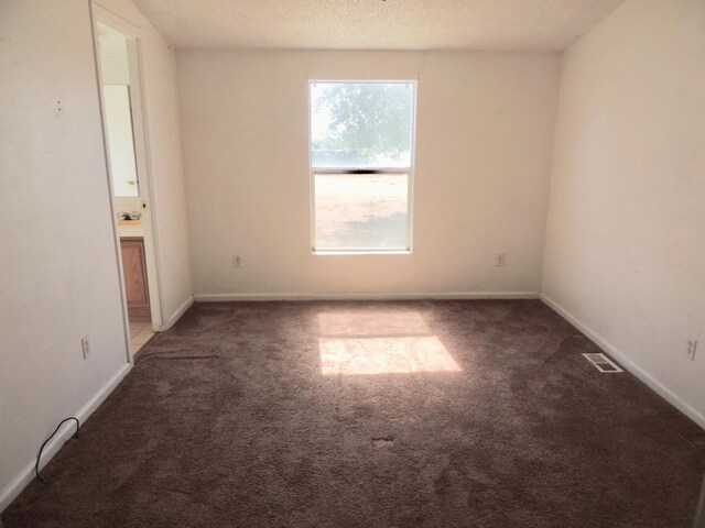 15716 S Hughes, Caruthers, CA 93609 - carpeted empty room featuring baseboards and a textured ceiling