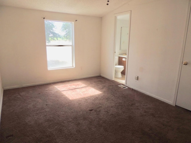 15716 S Hughes, Caruthers, CA 93609 - unfurnished bedroom with carpet flooring, ensuite bath, a textured ceiling, and vaulted ceiling