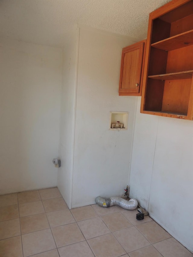 15716 S Hughes, Caruthers, CA 93609 - washroom with hookup for a washing machine, light tile patterned floors, and a textured ceiling