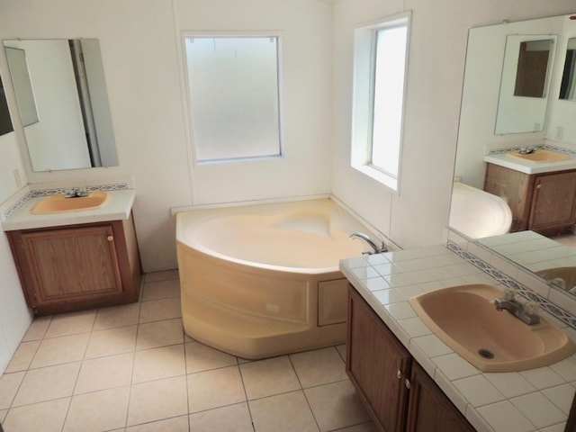 15716 S Hughes, Caruthers, CA 93609 - full bathroom featuring a bath, two vanities, and tile patterned flooring