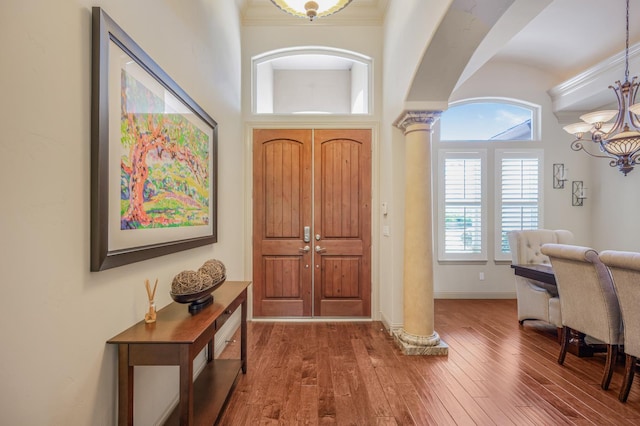 2136 E Royal Dornoch Ave, Fresno, CA 93730 - foyer entrance with ornate columns, wood finished floors, a chandelier, baseboards, and ornamental molding