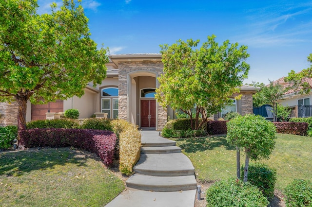 2136 E Royal Dornoch Ave, Fresno, CA 93730 - obstructed view of property featuring stone siding, a front lawn, and stucco siding