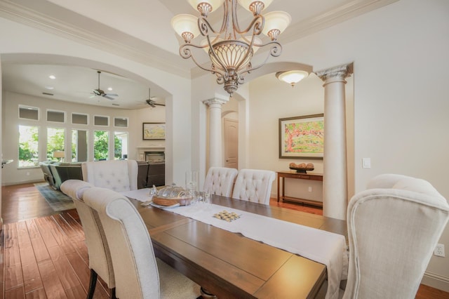 2136 E Royal Dornoch Ave, Fresno, CA 93730 - dining room featuring ceiling fan, arched walkways, ornate columns, a fireplace, and ornamental molding