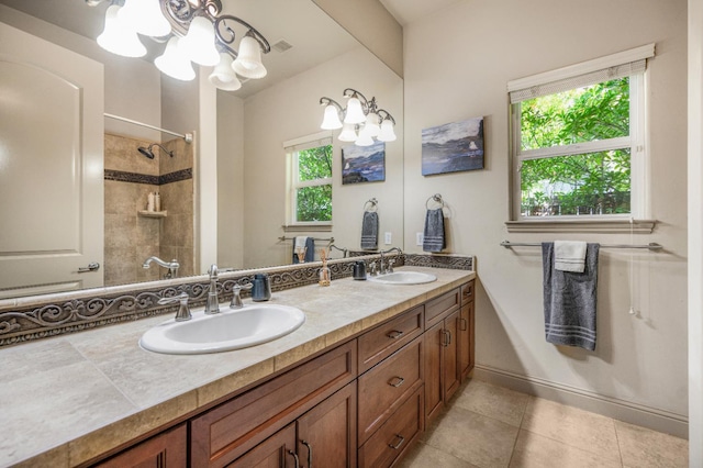 2136 E Royal Dornoch Ave, Fresno, CA 93730 - bathroom featuring a chandelier, double vanity, tile patterned flooring, and a tile shower