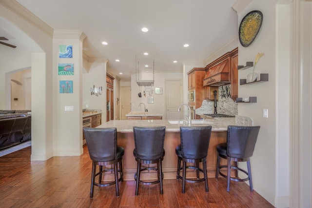 2136 E Royal Dornoch Ave, Fresno, CA 93730 - kitchen featuring a peninsula, a center island, dark wood-style floors, stainless steel microwave, and recessed lighting