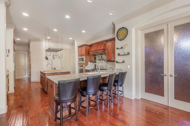 2136 E Royal Dornoch Ave, Fresno, CA 93730 - kitchen with appliances with stainless steel finishes, brown cabinetry, french doors, ornamental molding, and a peninsula