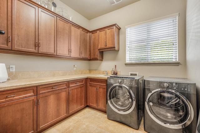 2136 E Royal Dornoch Ave, Fresno, CA 93730 - laundry area featuring independent washer and dryer, cabinet space, and light tile patterned flooring