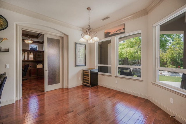 2136 E Royal Dornoch Ave, Fresno, CA 93730 - unfurnished dining area with plenty of natural light, ornamental molding, hardwood / wood-style flooring, a desk, and a chandelier