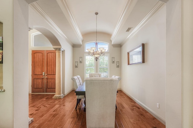 2136 E Royal Dornoch Ave, Fresno, CA 93730 - dining area with crown molding, ornate columns, vaulted ceiling, a chandelier, and light wood-style floors