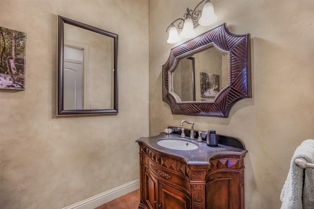 2136 E Royal Dornoch Ave, Fresno, CA 93730 - bathroom featuring vanity, wood finished floors, and baseboards