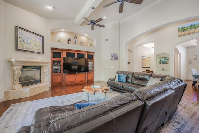 2136 E Royal Dornoch Ave, Fresno, CA 93730 - living area featuring arched walkways, wood finished floors, a ceiling fan, a premium fireplace, and recessed lighting