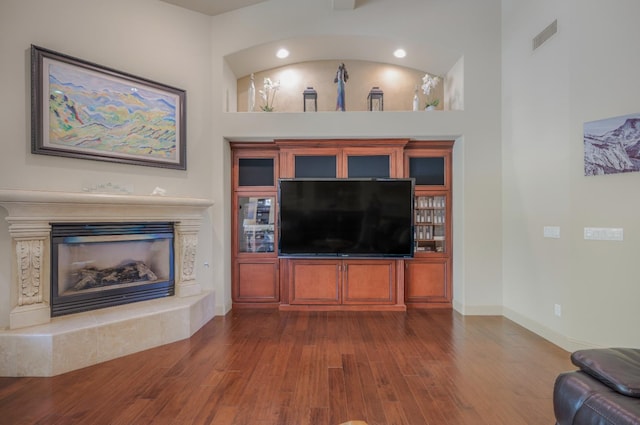 2136 E Royal Dornoch Ave, Fresno, CA 93730 - living area featuring dark wood-style flooring, a high end fireplace, and baseboards