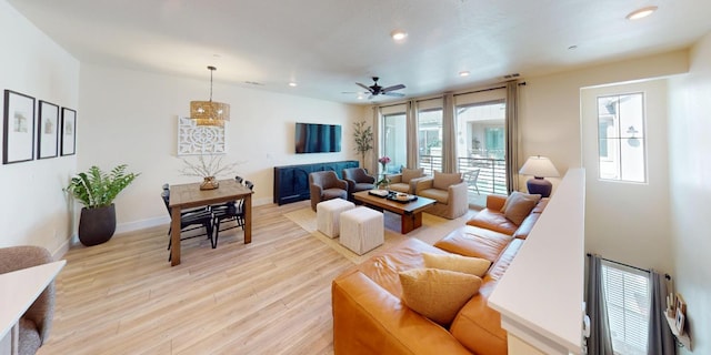 2897 E Tamarind Dr, Fresno, CA 93730 - living room with light wood finished floors, ceiling fan, recessed lighting, and baseboards