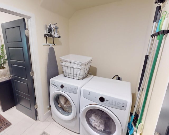 2897 E Tamarind Dr, Fresno, CA 93730 - laundry area with independent washer and dryer, light tile patterned flooring, and baseboards