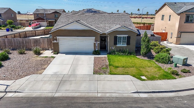 1985 Alma Ct, Chowchilla, CA 93610 - view of front of property with concrete driveway, stucco siding, a garage, and a residential view
