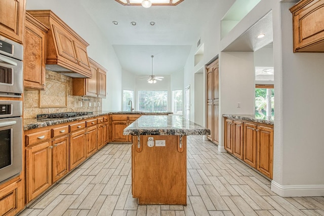 1251 E Rosemont Ln, Fresno, CA 93730 - kitchen with a sink, decorative backsplash, appliances with stainless steel finishes, light wood finished floors, and lofted ceiling