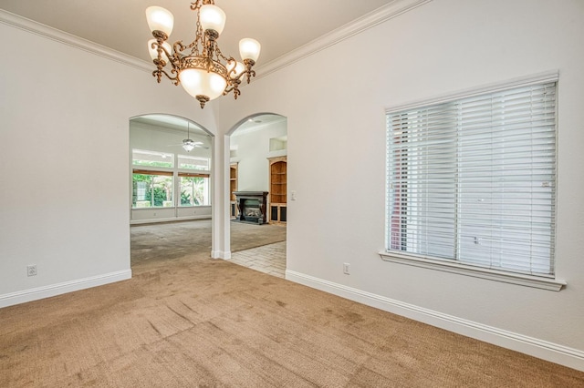 1251 E Rosemont Ln, Fresno, CA 93730 - carpeted spare room with arched walkways, ornamental molding, baseboards, a chandelier, and a fireplace