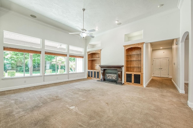 1251 E Rosemont Ln, Fresno, CA 93730 - unfurnished living room featuring ornamental molding, baseboards, plenty of natural light, carpet flooring, and a textured ceiling