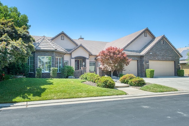 1251 E Rosemont Ln, Fresno, CA 93730 - view of front of house with a garage, a front lawn, driveway, and brick siding