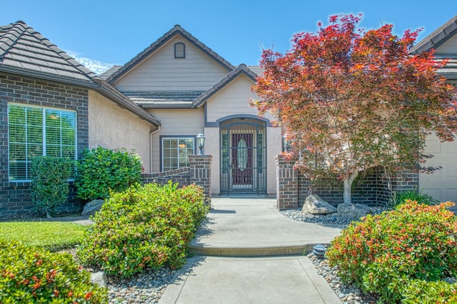 1251 E Rosemont Ln, Fresno, CA 93730 - doorway to property featuring a tile roof