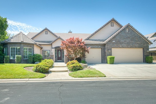 1251 E Rosemont Ln, Fresno, CA 93730 - traditional home featuring an attached garage, driveway, brick siding, a front yard, and a tiled roof