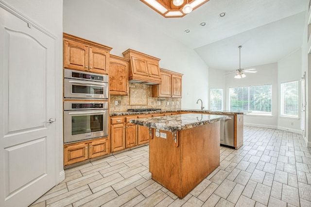 1251 E Rosemont Ln, Fresno, CA 93730 - kitchen with high vaulted ceiling, stainless steel appliances, a center island, tasteful backsplash, and a sink
