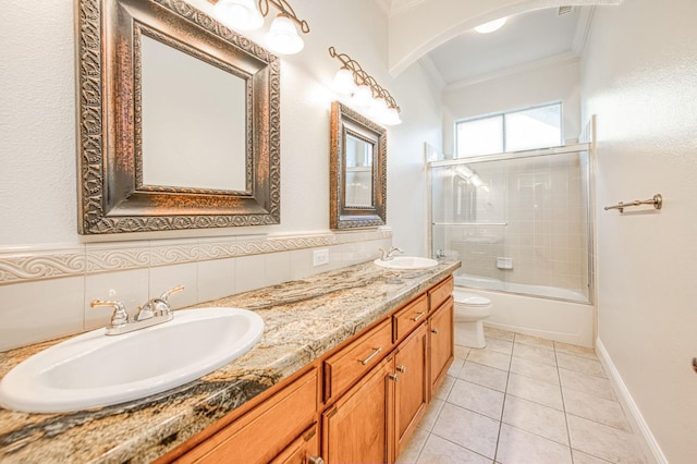 1251 E Rosemont Ln, Fresno, CA 93730 - bathroom with crown molding, toilet, double vanity, enclosed tub / shower combo, and tile patterned flooring
