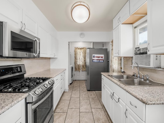 1632 W Shields Ave, Fresno, CA 93705 - kitchen with appliances with stainless steel finishes, a sink, white cabinets, and tasteful backsplash
