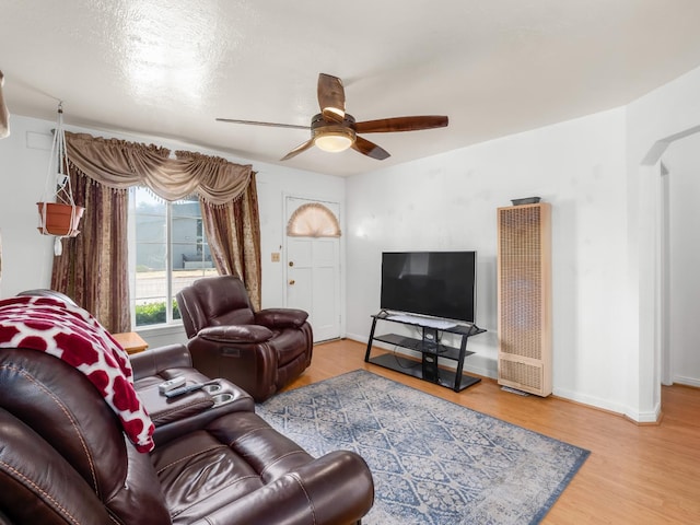 1632 W Shields Ave, Fresno, CA 93705 - living room with a heating unit, a ceiling fan, wood finished floors, baseboards, and arched walkways