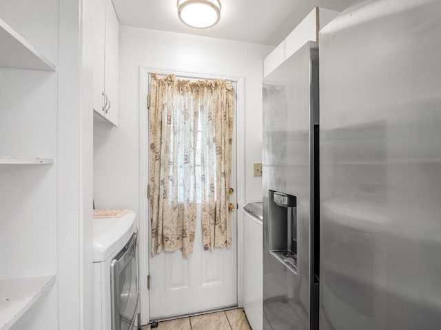 1632 W Shields Ave, Fresno, CA 93705 - washroom with washer and dryer, light tile patterned floors, and cabinet space