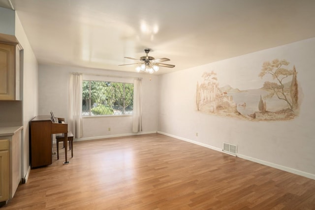 1438 E Rialto Ave, Fresno, CA 93704 - unfurnished living room with light wood-type flooring, a ceiling fan, and baseboards