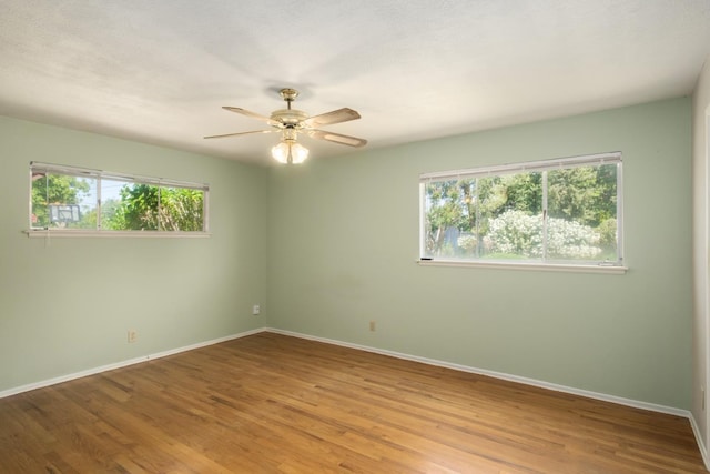 1438 E Rialto Ave, Fresno, CA 93704 - unfurnished room featuring healthy amount of natural light, baseboards, a ceiling fan, and wood finished floors