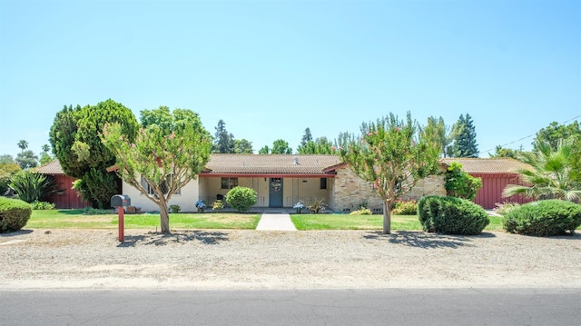 1438 E Rialto Ave, Fresno, CA 93704 - ranch-style home featuring a tile roof, stucco siding, and a front yard