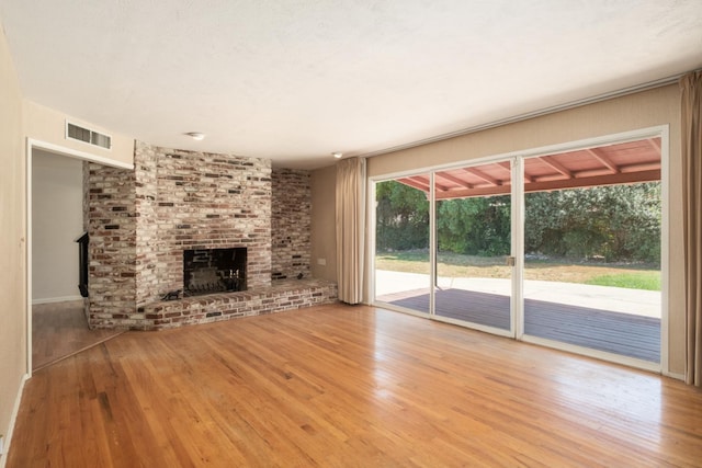 1438 E Rialto Ave, Fresno, CA 93704 - unfurnished living room with wood finished floors and a fireplace