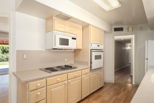 1438 E Rialto Ave, Fresno, CA 93704 - kitchen featuring white appliances, light wood-style flooring, light countertops, and light brown cabinets