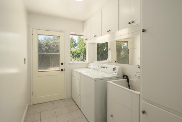 1438 E Rialto Ave, Fresno, CA 93704 - washroom with washer and clothes dryer, cabinet space, light tile patterned flooring, and baseboards