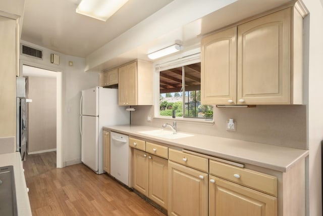 1438 E Rialto Ave, Fresno, CA 93704 - kitchen with a sink, white appliances, light wood finished floors, light brown cabinets, and light countertops