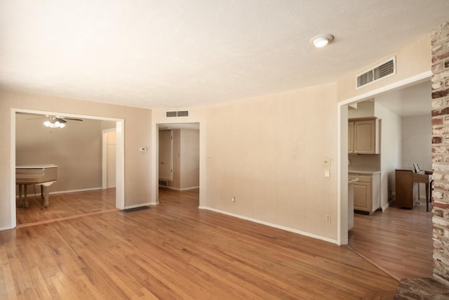 1438 E Rialto Ave, Fresno, CA 93704 - unfurnished living room featuring light wood finished floors, ceiling fan, and baseboards