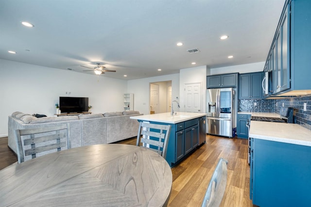 6659 E Vassar Ave, Fresno, CA 93727 - kitchen featuring appliances with stainless steel finishes, blue cabinetry, a ceiling fan, light countertops, and recessed lighting