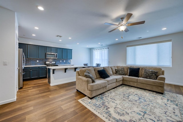 6659 E Vassar Ave, Fresno, CA 93727 - living room featuring a ceiling fan, wood finished floors, recessed lighting, and baseboards