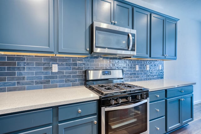 6659 E Vassar Ave, Fresno, CA 93727 - kitchen with stainless steel appliances, tasteful backsplash, light countertops, and blue cabinets